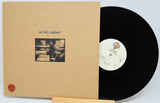 Tom Petty's 'Self Owned' vinyl record album, showing the tan paper sleeve with handwritten title and black-and-white photo, next to the black LP record on a white background.
