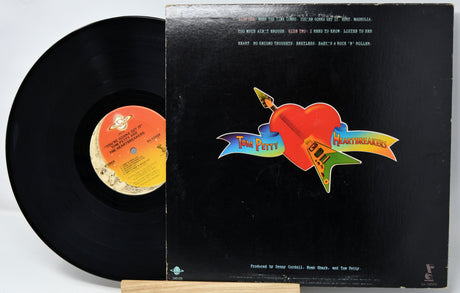 Vinyl record with its cover featuring a colorful logo on a white background