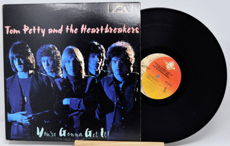 Vinyl record with 'Tom Petty and the Heartbreakers' album cover showing band members.