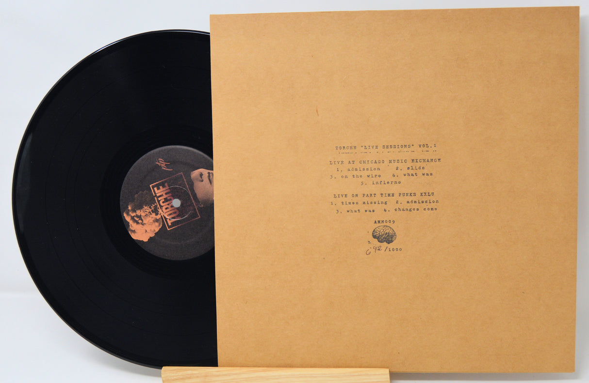 Vinyl record with a brown cover displaying track listings on a light gray background