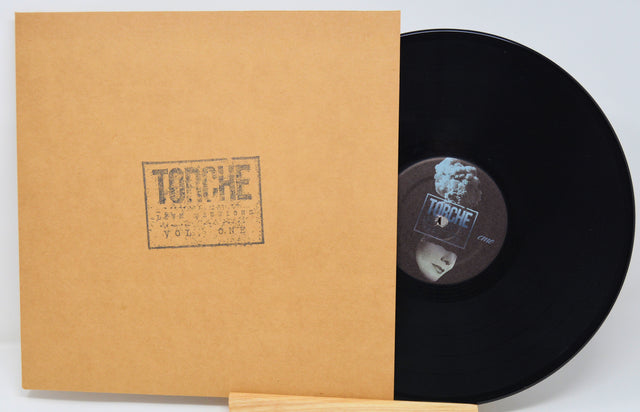 Vinyl record with a brown sleeve featuring a logo on a light gray background