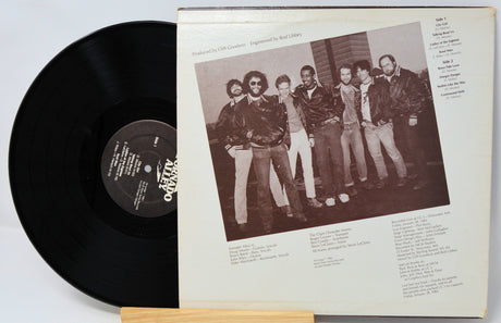 Vinyl record with cover featuring a group of people on a white background