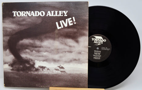 Vinyl record and cover titled 'Tornado Alley Live!' with a tornado graphic on the cover.