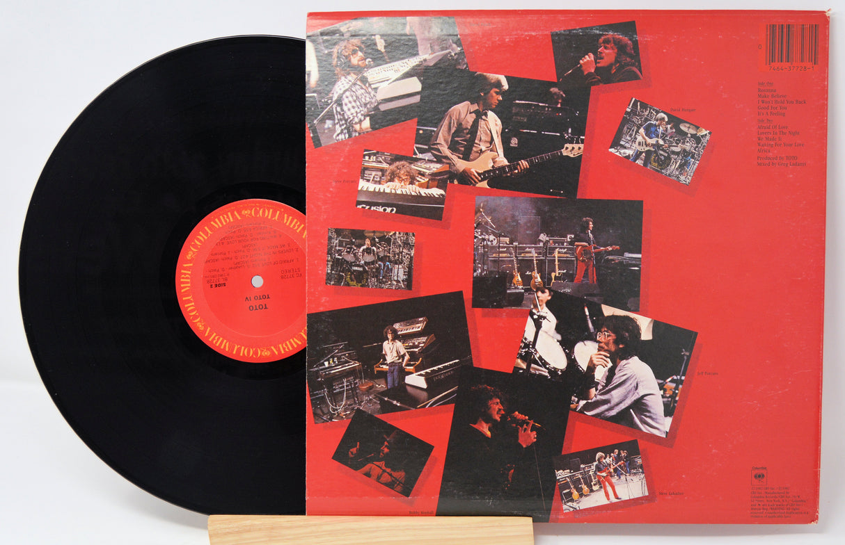 Vinyl record with a red cover featuring black and white photos of a musician.