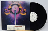 Vinyl record with a colorful cover featuring the band Toto's logo.