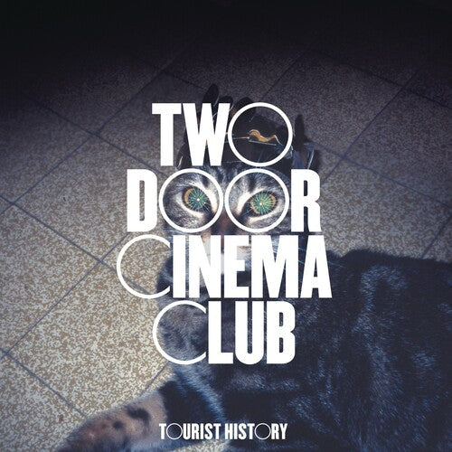Two Door Cinema Club Tourist History album cover featuring bold white text and a cat's face