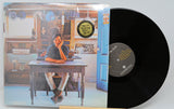 Front cover of Townes Van Zandt vinyl record with the artist seated at a rustic table