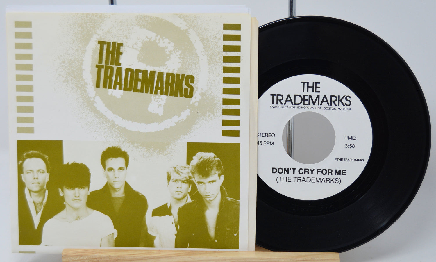 Vinyl record and cover with 'The Trademarks' on a white background