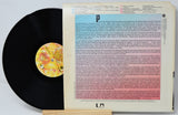 Vinyl record with a colorful label and text on a white background
