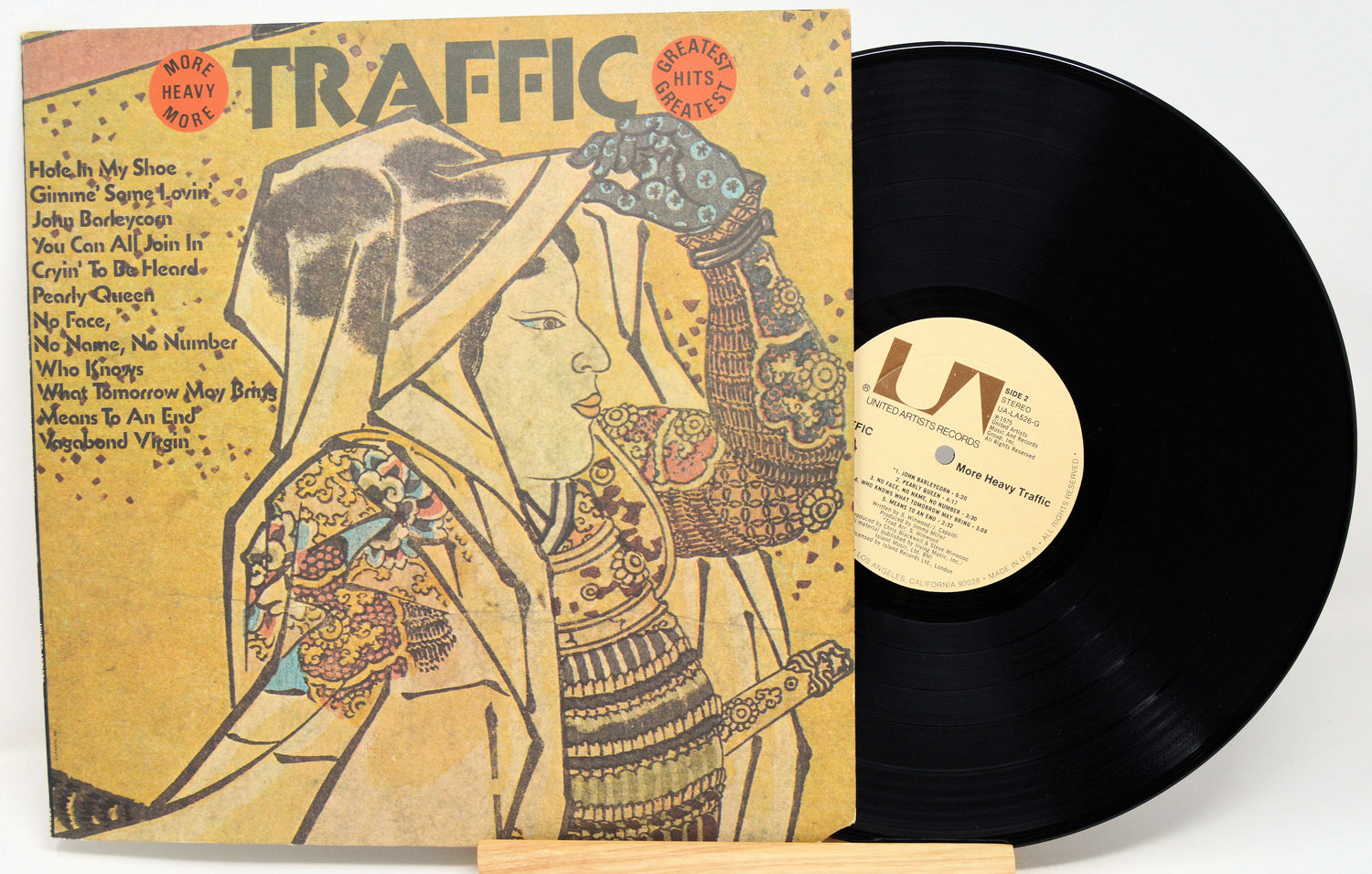 Vinyl record with cover featuring an artistic design of a woman, titled 'Traffic'.