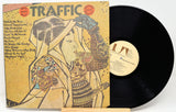 Vinyl record with cover featuring an artistic design of a woman, titled 'Traffic'.