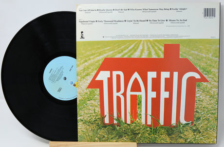 Vinyl record with red cover featuring black and white images of a musician and track listings.