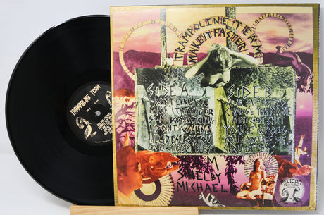 Shelby Michael's 'Trampoline to Tread' vinyl record LP with its illustrated cover jacket displayed next to the black record on a small wooden stand.