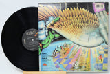 Vinyl record with colorful album cover featuring a futuristic design.