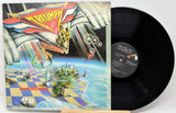 Vinyl record with colorful album cover featuring 'Triumph' and 'Just a Game'.