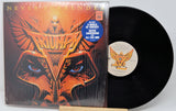 Vinyl record with cover featuring a stylized face design and 'Never Surrender' text.