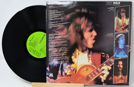 Vinyl record with a colorful album cover featuring a musician playing guitar.