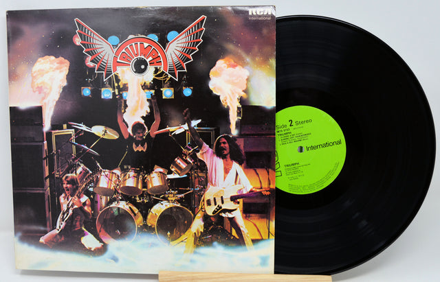 Vinyl record with a colorful cover featuring musicians and flames on a white background