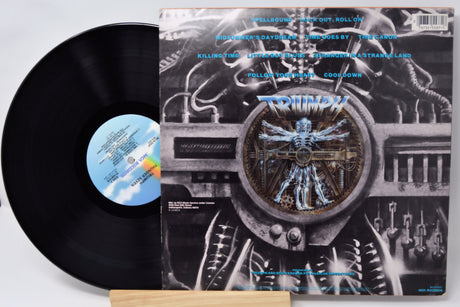 Vinyl record with its cover featuring intricate design and text.