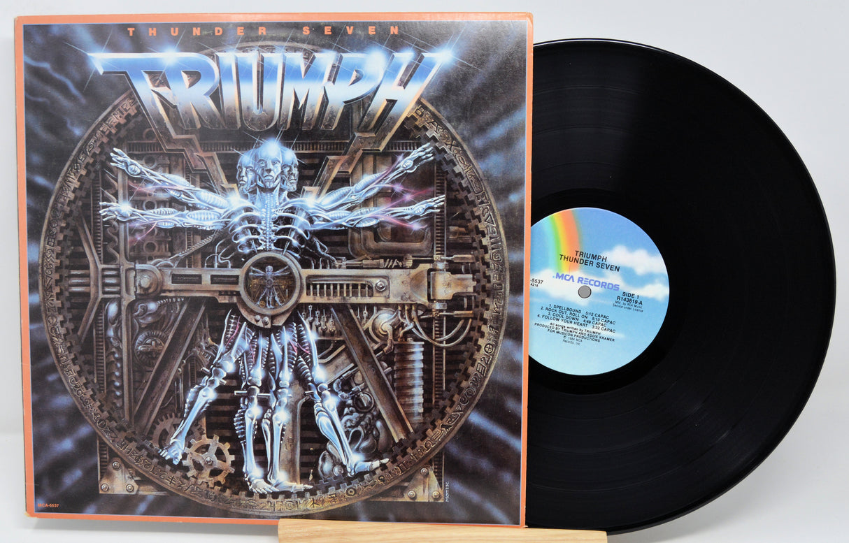 Vinyl record with cover featuring a mechanical design and 'Triumph' branding.