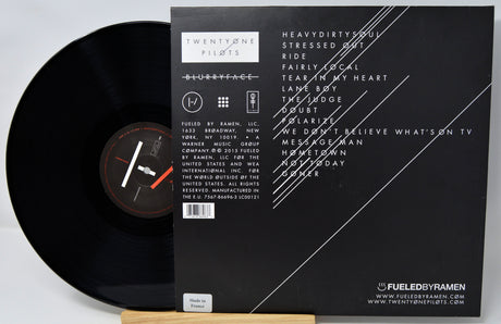 Vinyl record with its cover displaying text and branding.