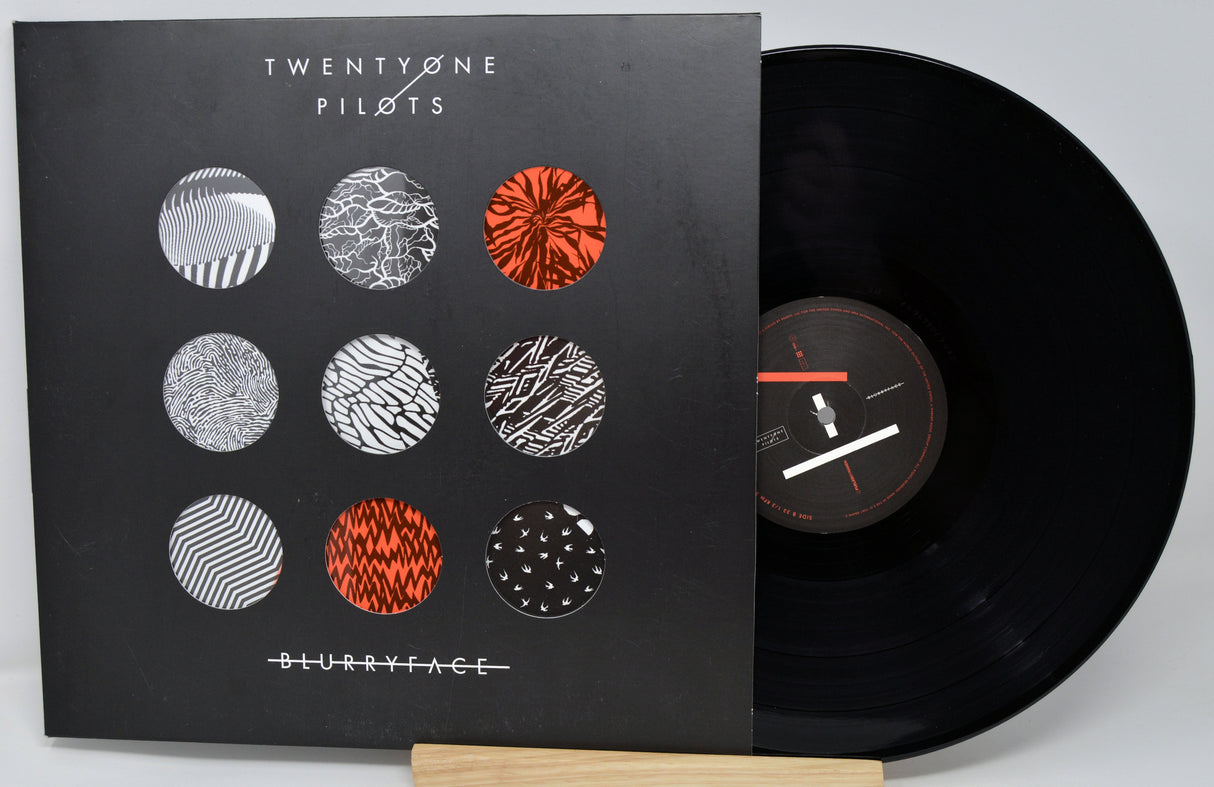 Vinyl record with cover featuring 'Twenty One Pilots' album art on a gray background