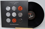 Vinyl record with cover featuring 'Twenty One Pilots' album art on a gray background