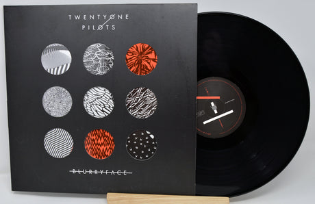 Vinyl record with cover featuring 'Twenty One Pilots' album art on a gray background
