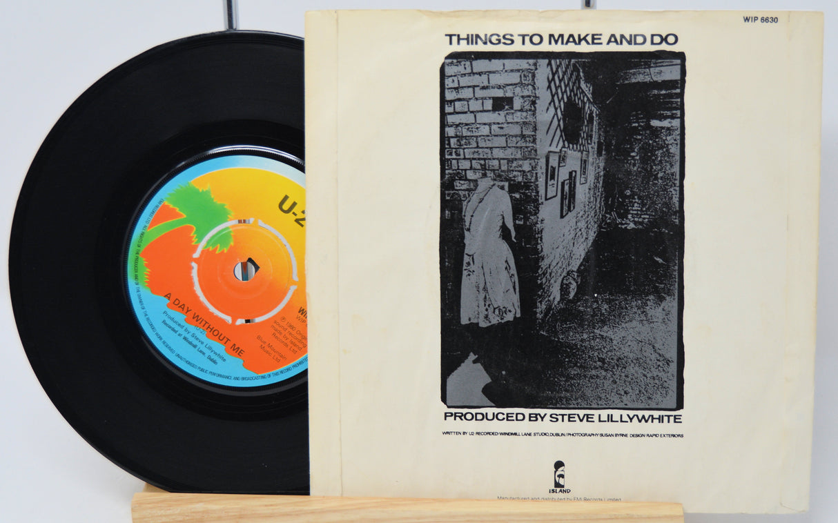 Vinyl record and its cover with a black and white illustration on a white background
