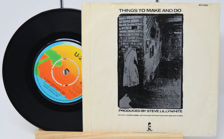 Vinyl record and its cover with a black and white illustration on a white background