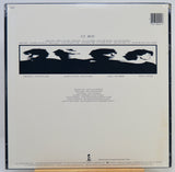 The back cover of a U2 - Boy vinyl record, showing track listing, credits, and a black silhouette band photo on an off-white background.