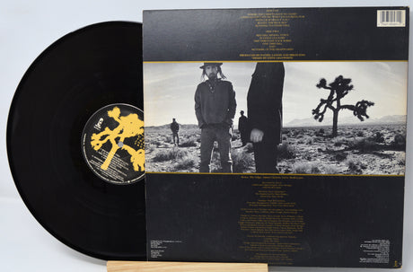 Vinyl record with matching cover featuring a desert landscape and person.