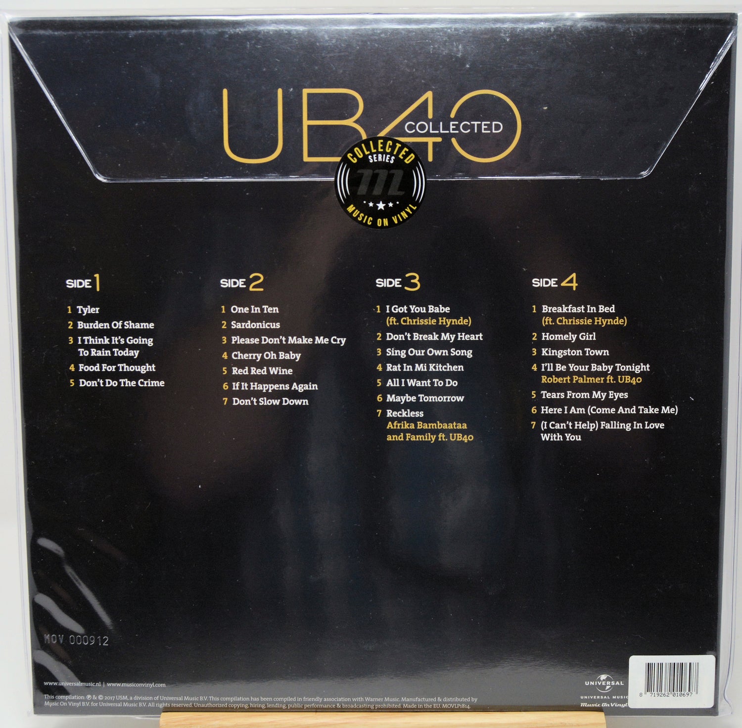 The back cover of a UB40 'Collected' vinyl record package, featuring the album title in large gold letters, track listings for Side 1 through Side 4, and a central circular 'Collector's Edition of CD 1-2' badge on a black background.