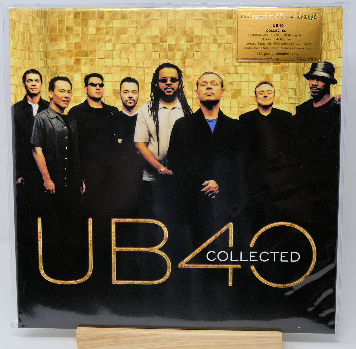UB40 'Collected' 12-inch vinyl record album cover, featuring the band members against a gold tiled background with large gold 'UB40' lettering and 'COLLECTED' text on a black lower section.
