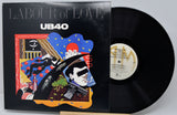 Vinyl record with cover titled 'Labour of Love' by UB40 on a gray background