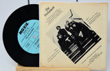 Vinyl record with cover featuring a band photo and text on a white background