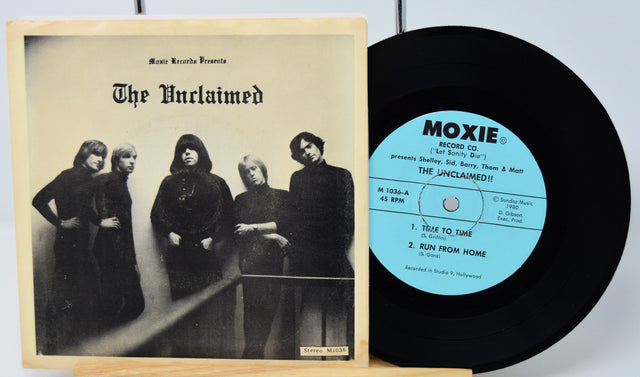 Vinyl record with cover featuring 'The Unclaimed' band and Moxie Records branding.