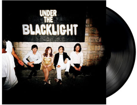 Vinyl record with cover showing a group of people sitting against a wall, titled 'Under the Blacklight'.