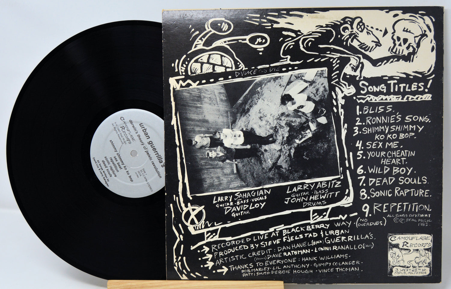 Vinyl record with cover featuring a stylized illustration of a person and text.