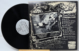 Vinyl record with cover featuring a stylized illustration of a person and text.