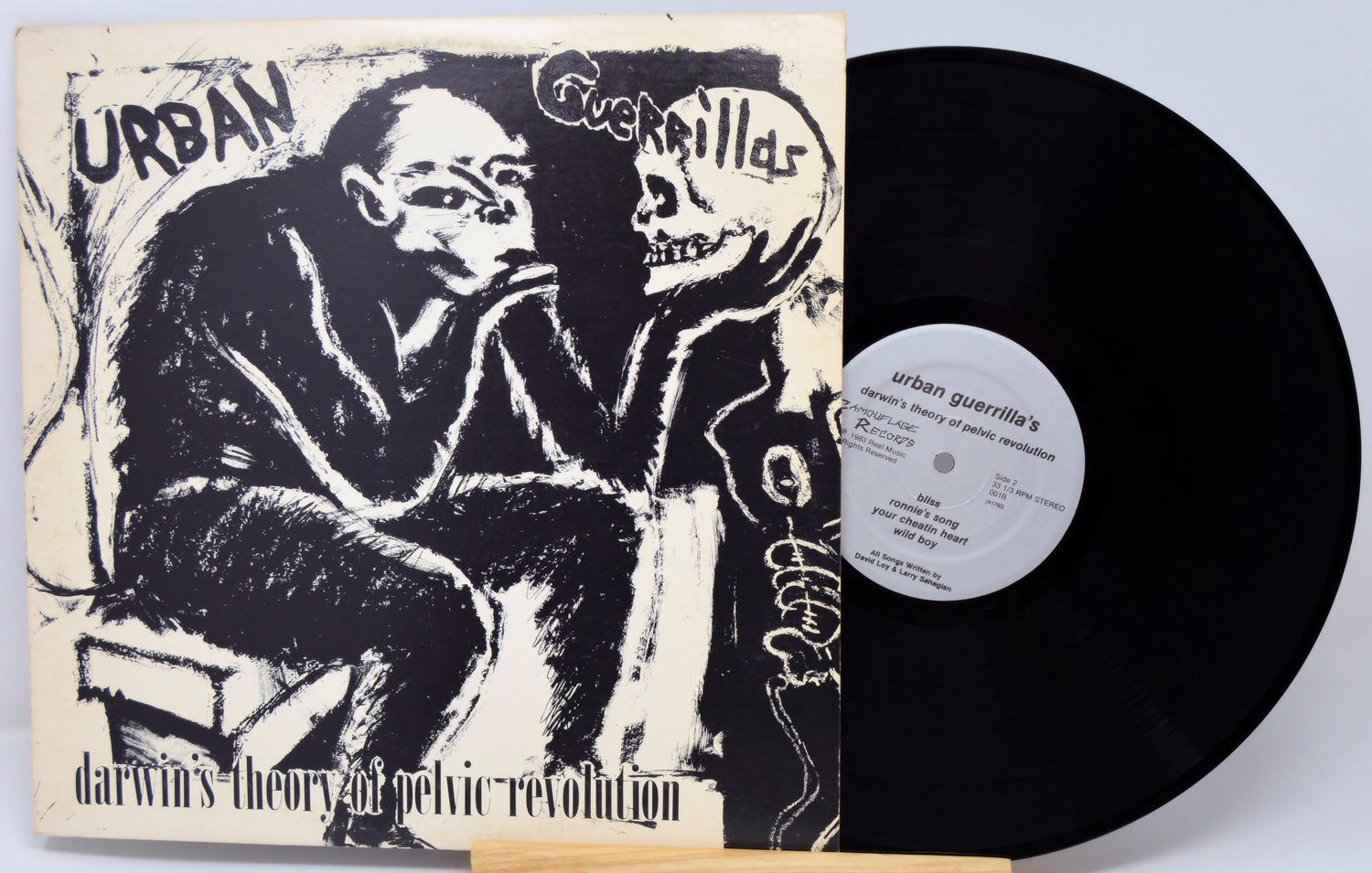 Vinyl record with cover featuring a stylized illustration of a person and text.