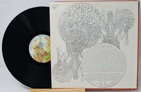 A black vinyl record partially pulled from its illustrated album cover, displayed on a small wooden stand against a light gray background.