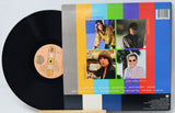 Vinyl record with colorful cover featuring a collage of images and text