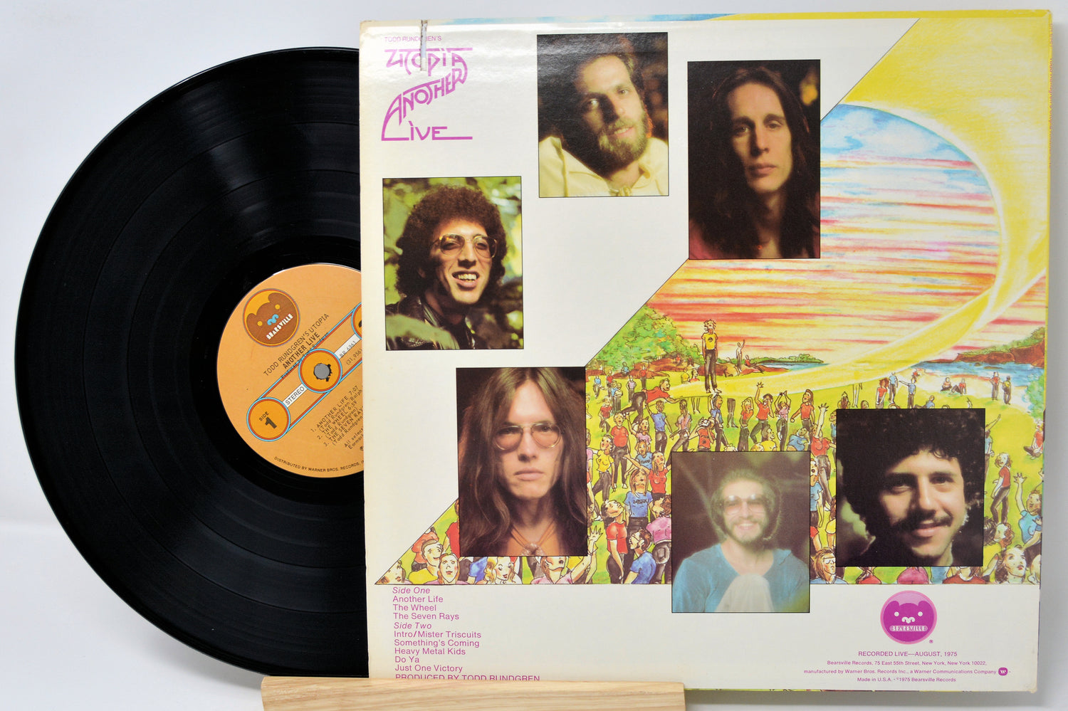 Vinyl record with a colorful album cover featuring portraits and abstract designs.
