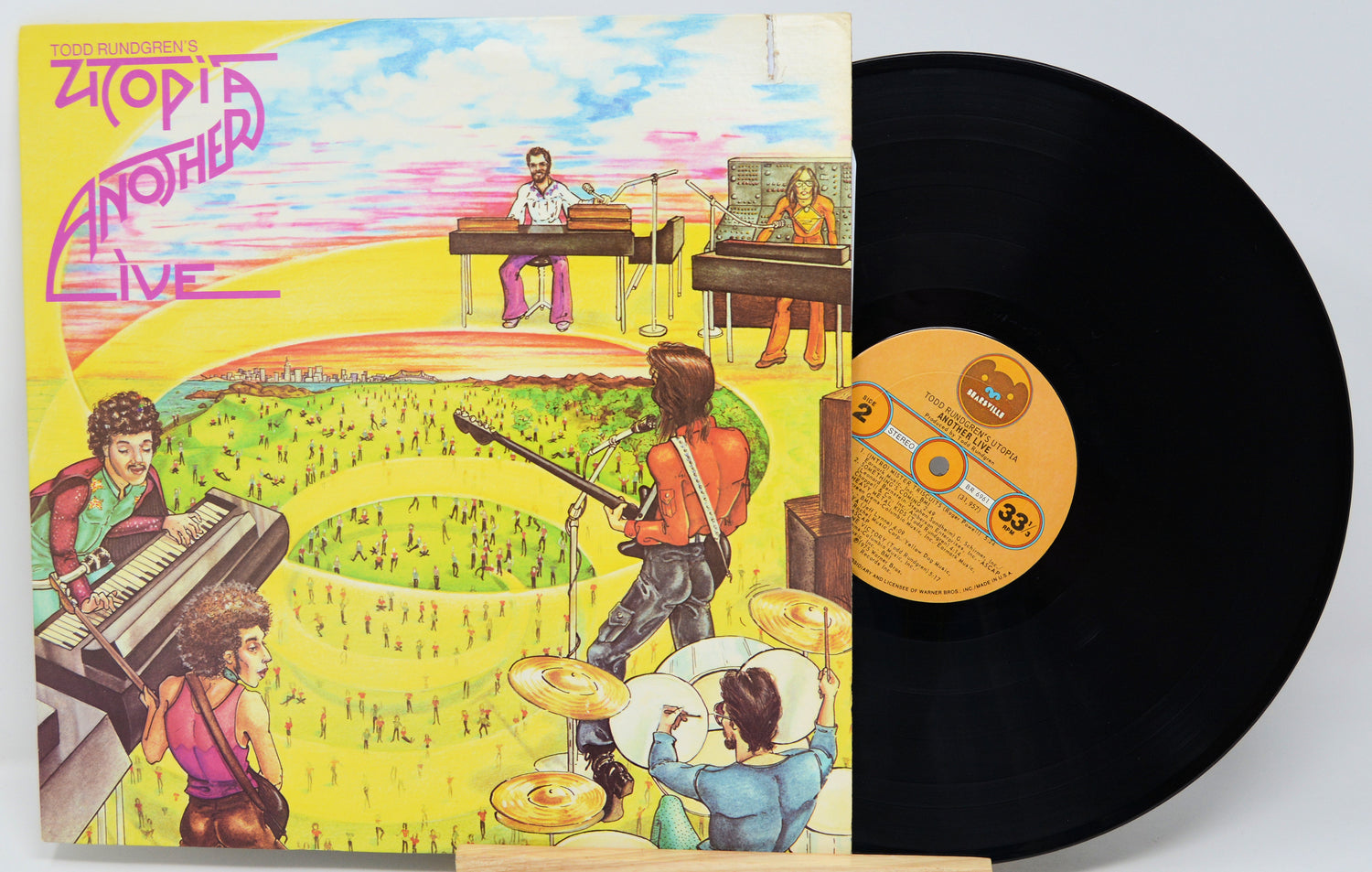 Vinyl record with a colorful cover featuring musicians and a crowd, labeled 'Zoots Another Live'.