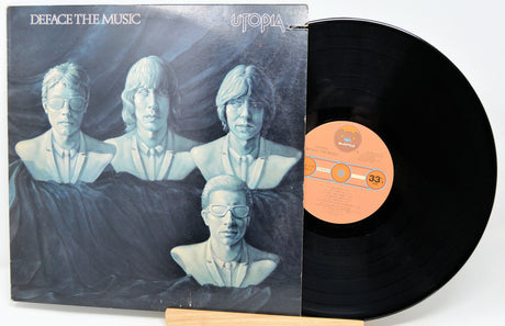 Vinyl record with a cover featuring a group of people in a barn setting