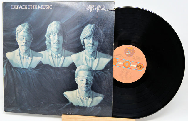 Vinyl record with a cover featuring a group of people in a barn setting