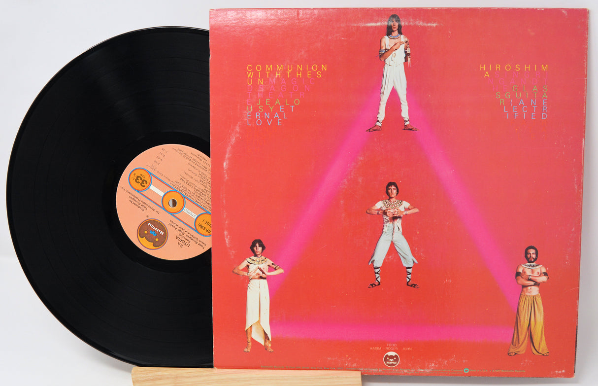 Vinyl record with a colorful album cover featuring people in a geometric design.