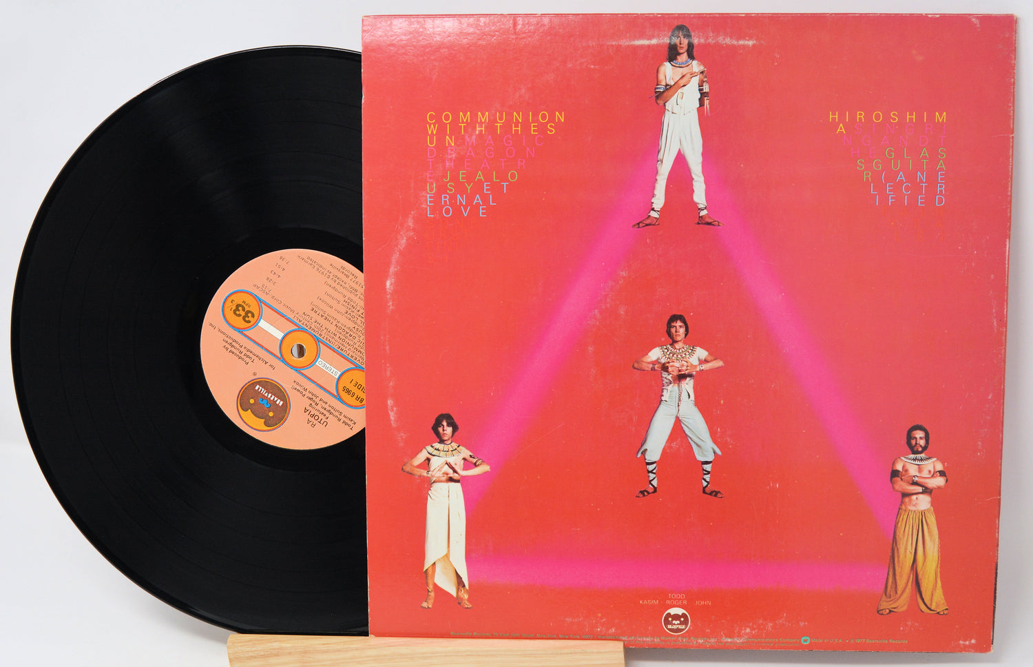 Vinyl record with a colorful album cover featuring people in a geometric design.
