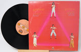 Vinyl record with a colorful album cover featuring people in a geometric design.
